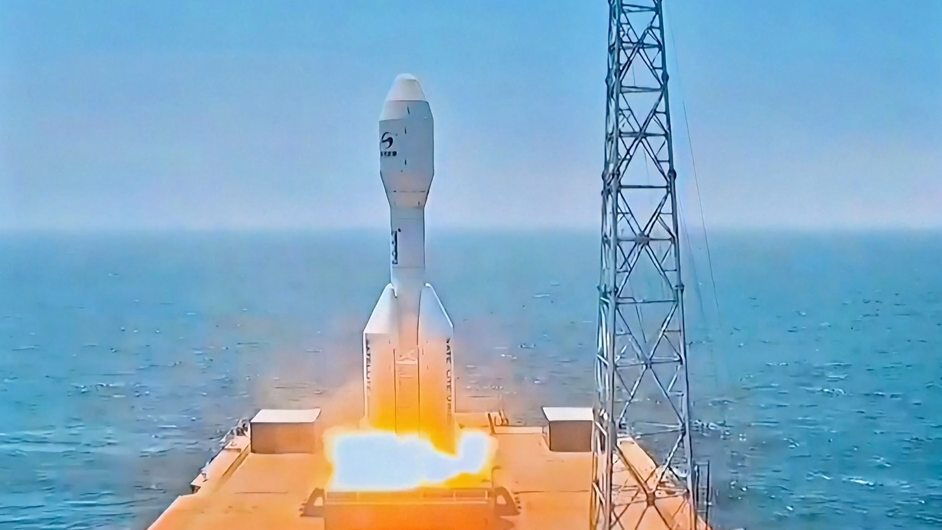 航天图片资料 · a short white rocket launches from the deck of a ship at sea