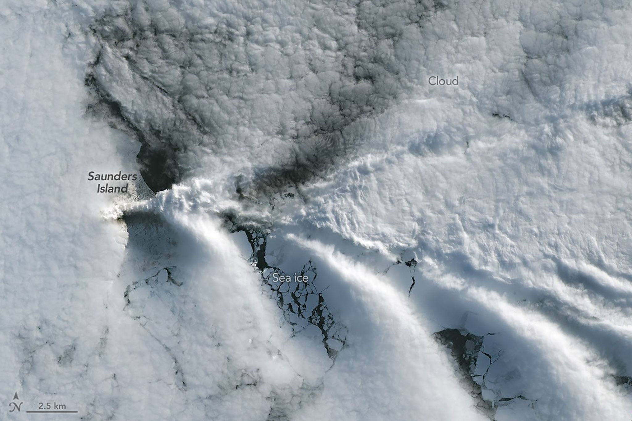 航天图片资料 · A series of V-shaped wave clouds appears over an ocean filled with pieces of sea ice.