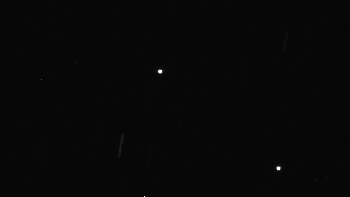 航天图片资料 · a bright white dot approaches another bright white dot as background stars zoom by at high speed