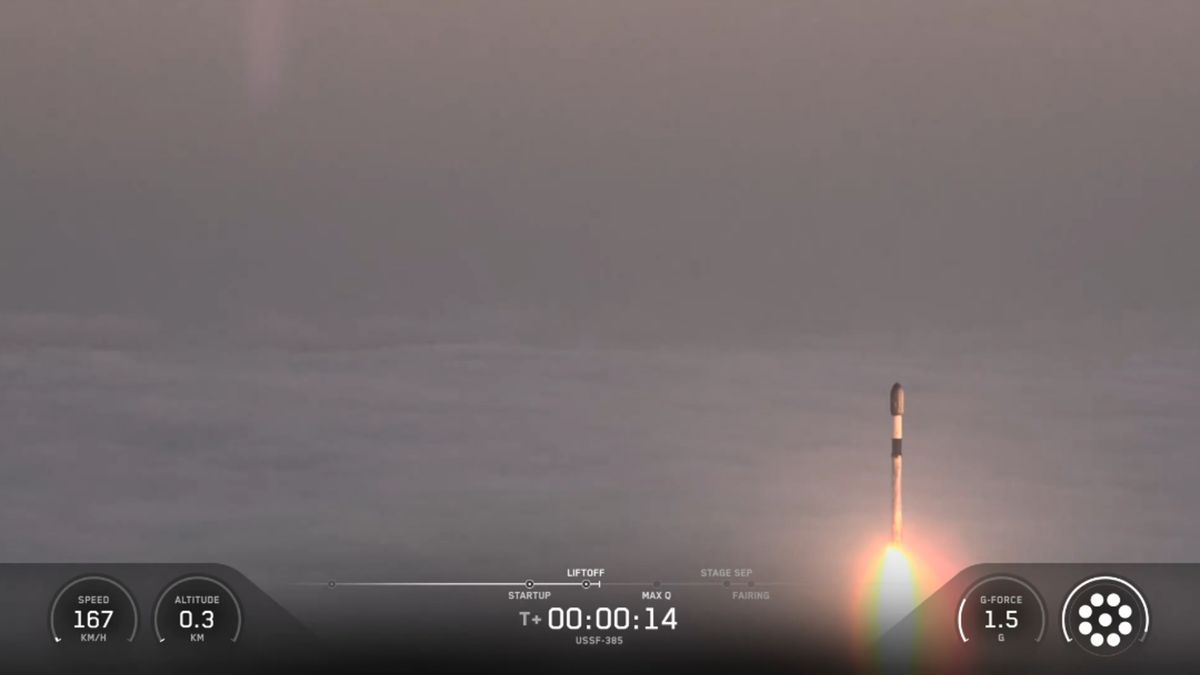 航天图片资料 · A SpaceX rocket rises out of the clouds and fog during a classified launch to space.