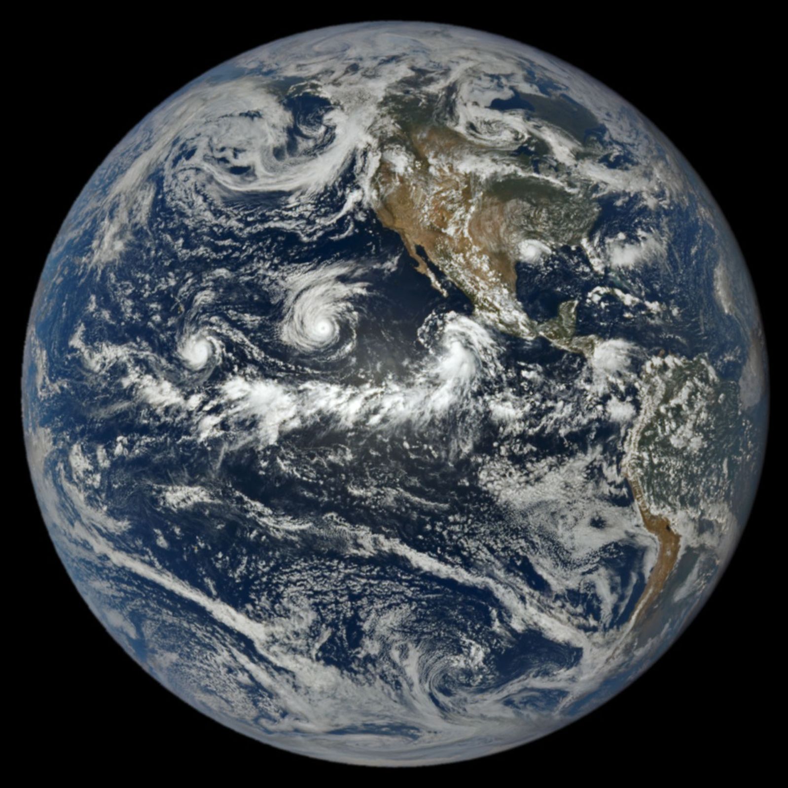 航天图片资料 · In a full-disk satellite view of Earth, three tropical cyclones—named Lowell, Karina, and Marie—swirl above the blue waters of the Pacific Ocean and to the west of Central America.