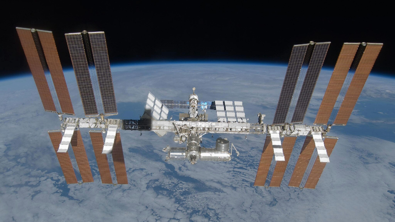 航天图片资料 · An image of the International Space Station, with its many solar panels and modules, floating above Earth in space