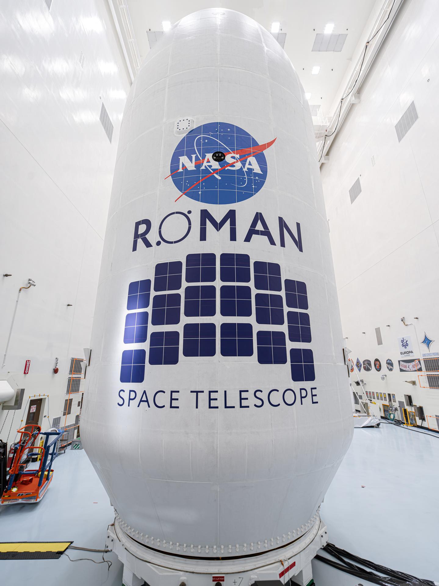 航天图片资料 · Close-up view of the Roman Space Telescope’s payload, wrapped in white covering with the NASA logo and Roman Space Telescope insignia displayed prominently.