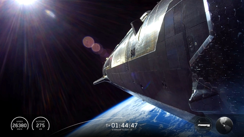 航天图片资料 · Sun shining on large, cylindrical spacecraft covered in black thermal tiles, in space, with Earth below.