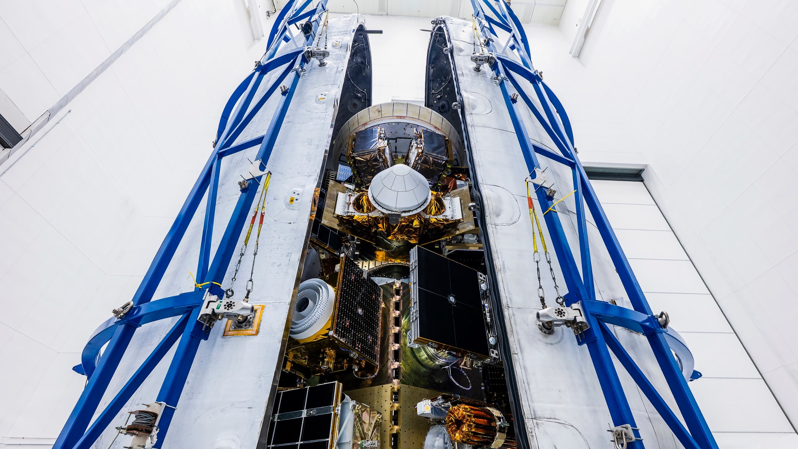 航天图片资料 · photo of a stack of satellites being processed for launch inside a large white clean room