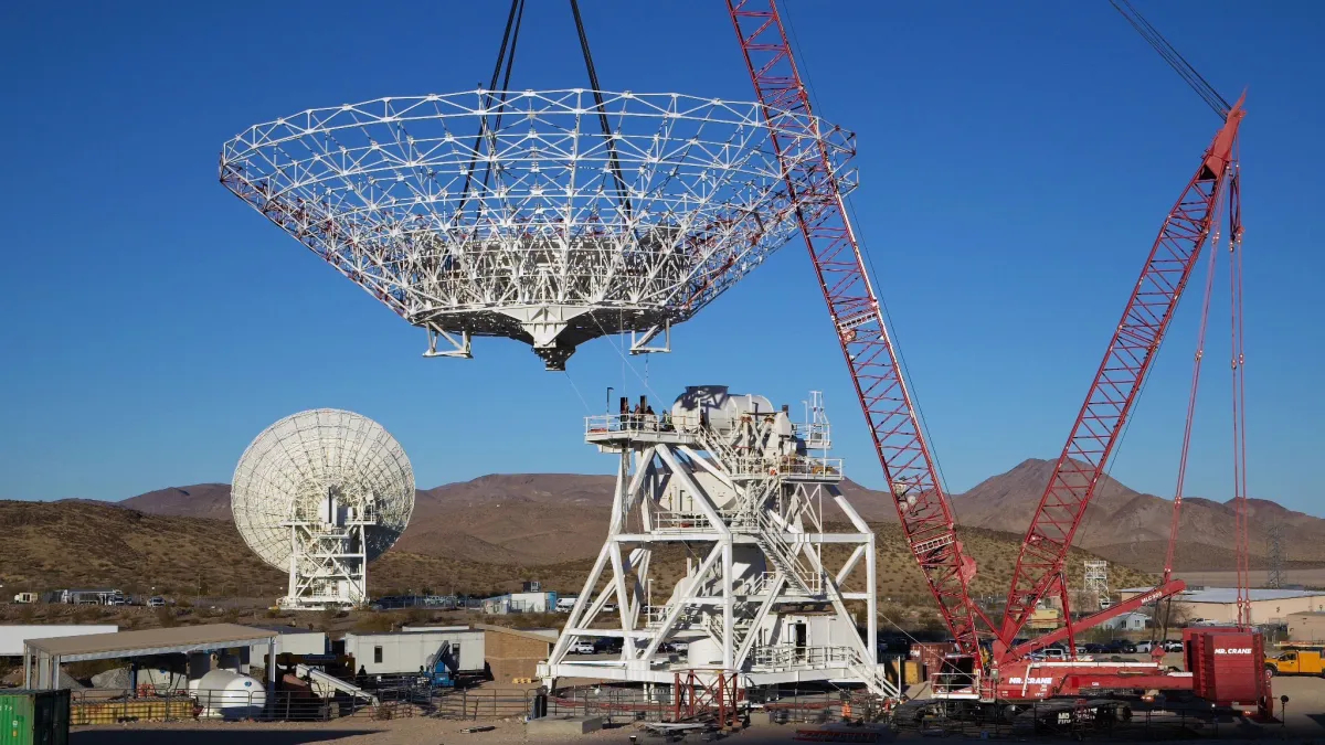 航天图片资料 · A crane lowers a giant NASA radio dish into place while building Deep Space Station 23 on Dec. 18, 2024.