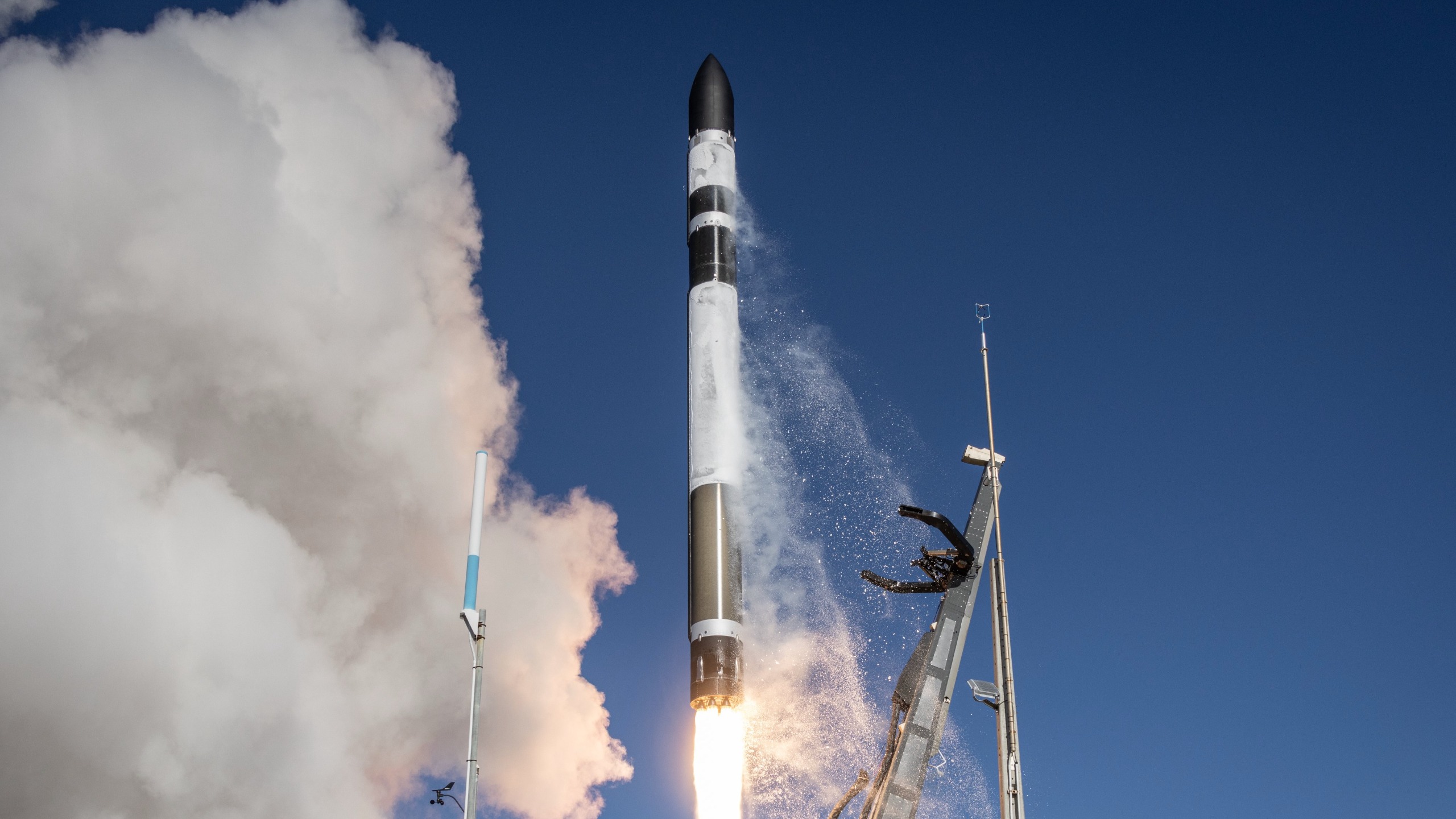 航天图片资料 · a black and white rocket launches into a blue sky