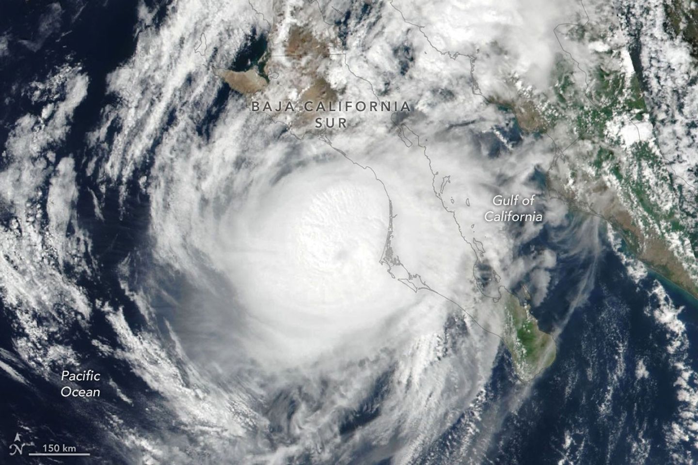 航天图片资料 · Hurricane Polo’s clouds spiral over the Pacific Ocean and the Baja California peninsula. The storm’s faint eye is just off the west coast of the peninsula.