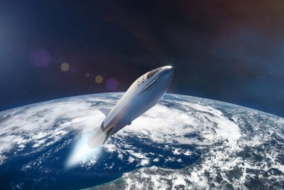 航天图片资料 · A sleek, white and silver rocket, resembling a SpaceX Starship, ascends diagonally from the lower left towards the upper right. Bright blue engine exhaust streams downwards, partially obscured by white clouds on Earth. The Earth's curvature is prominent, showing vast blue oceans and white clouds below, with a coastline visible at the bottom right. The upper portion of the image is dark outer space with faint stars and subtle lens flares.