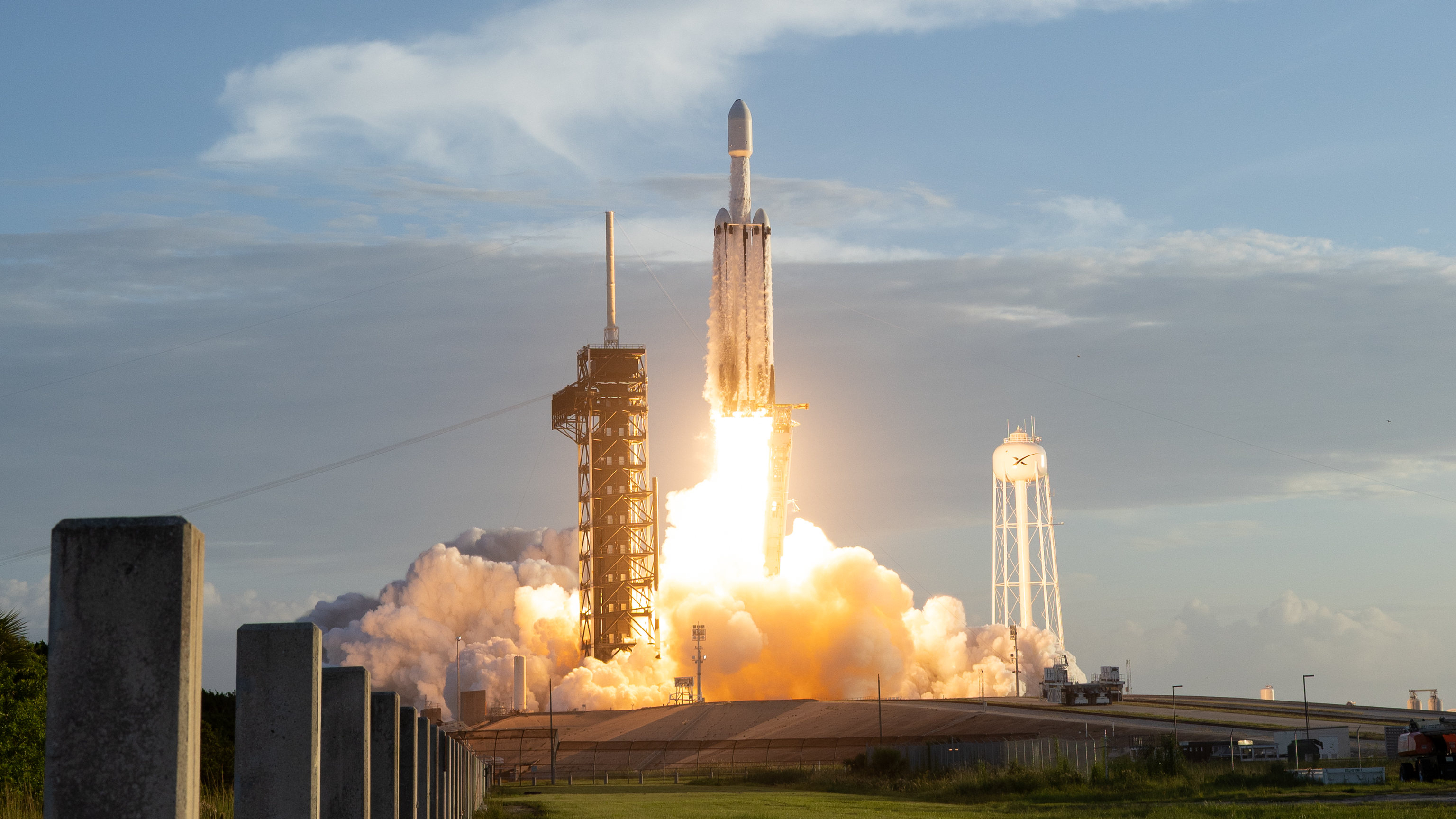 航天图片资料 · a large white rocket launches from a seaside pad