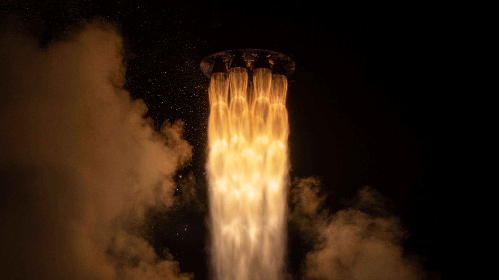 航天图片资料 · closeup of a the fiery plume produced by a black and white rocket during its nighttime liftoff
