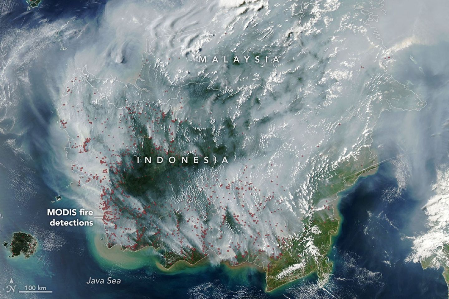 航天图片资料 · The locations of MODIS fire detections are depicted with small red circles. Most are visible on the southern side of the island.