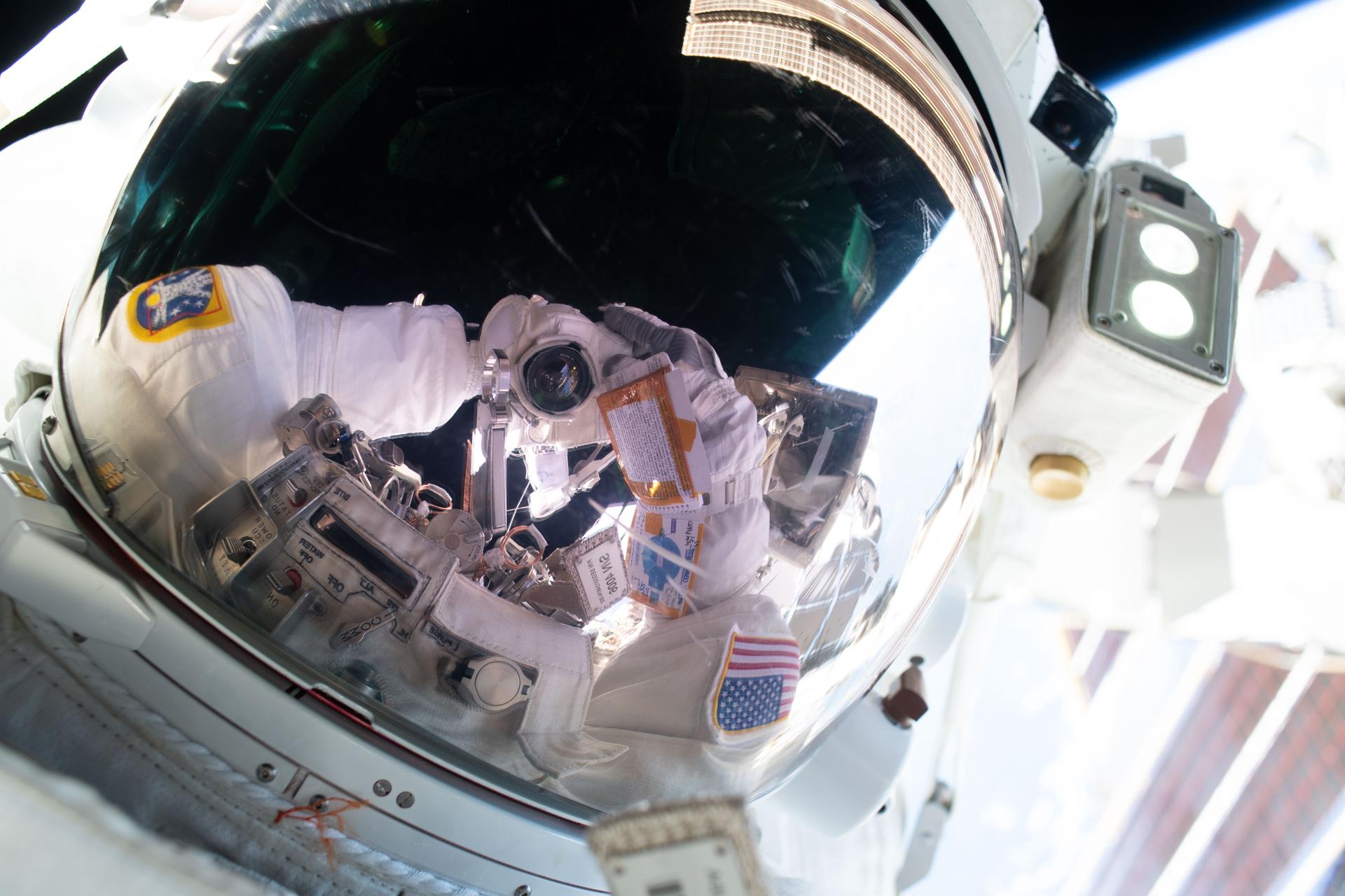 航天图片资料 · NASA astronaut and Expedition 75 flight engineer Anil Menon points his camera toward his spacesuit’s helmet visor and takes an out-of-this-world “space selfie.” Menon participated in a six-hour and 30-minute spacewalk with ESA (European Space Agency) astronaut and Expedition 75 flight engineer Sophie Adenot (out of frame) to install a high-speed space-to-ground antenna outside the International Space Station.