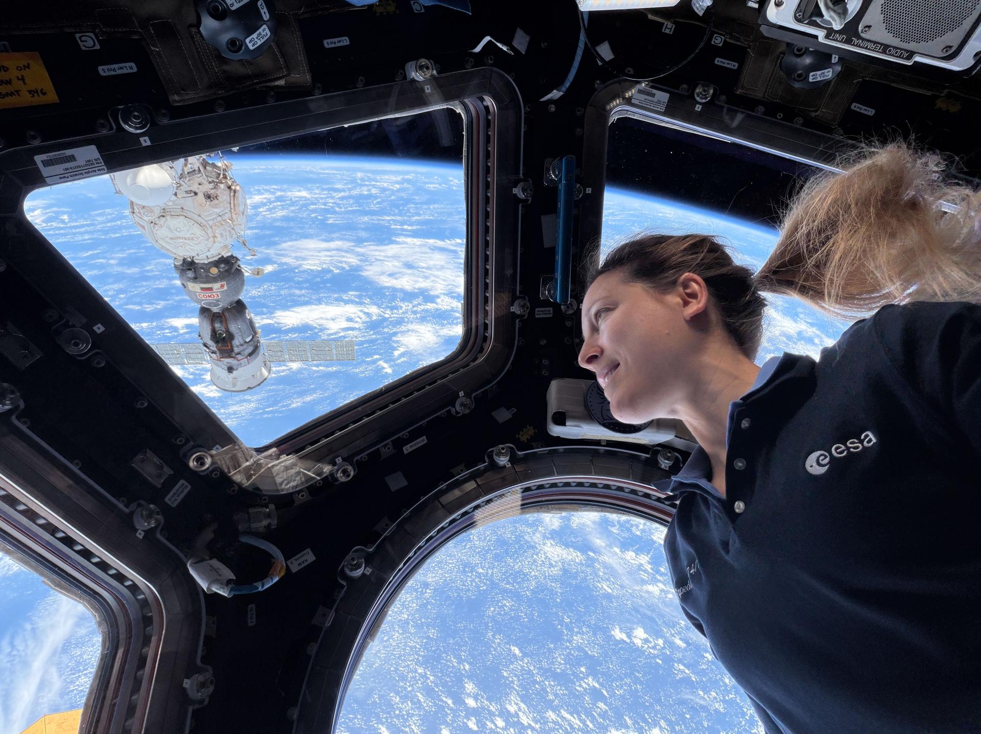 航天图片资料 · ESA (European Space Agency) astronaut and Expedition 75 flight engineer Sophie Adenot looks at the Earth below from the cupola, the International Space Station's "window to the world." Just outisde the cupola is the Soyuz MS-29 spacecraft from Roscosmos docked to the Prichal module.