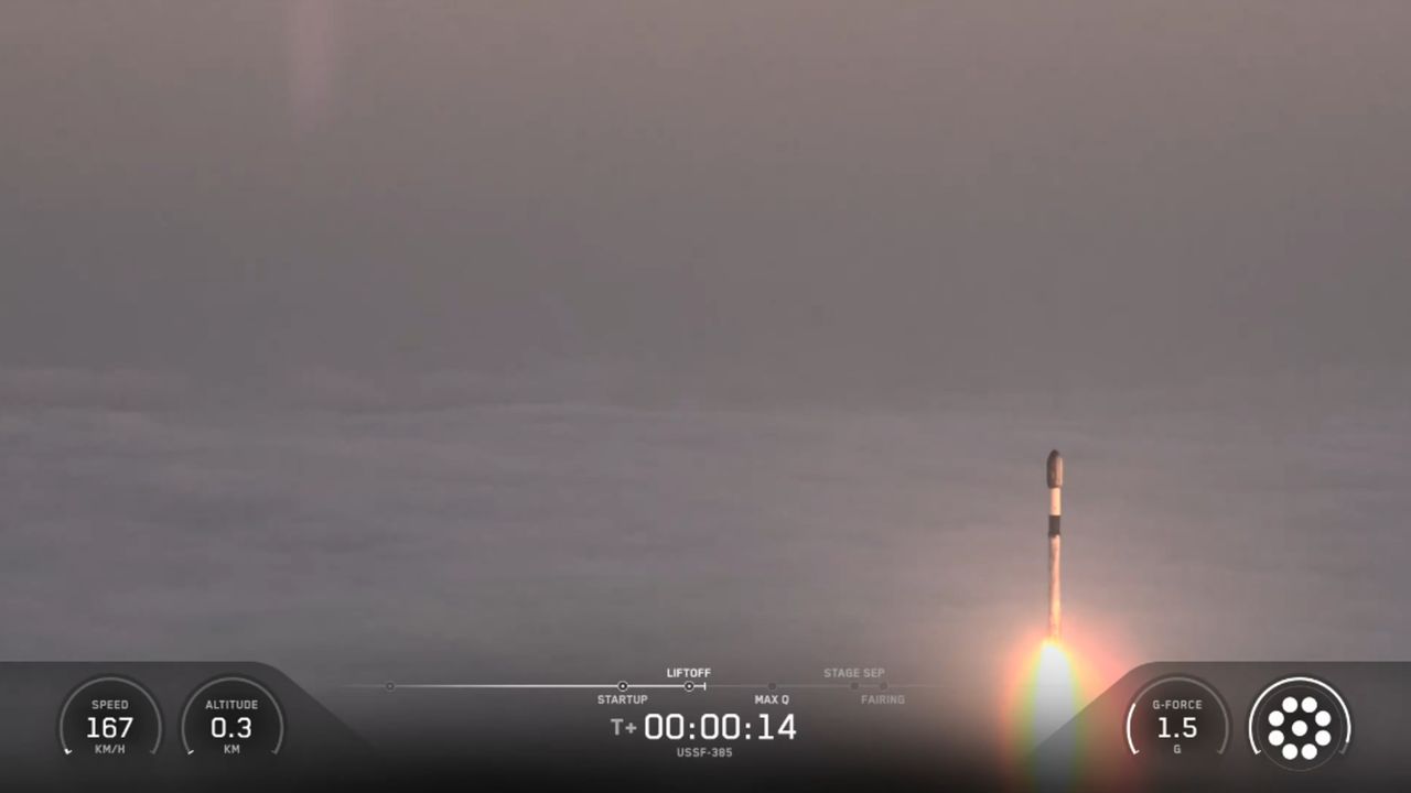 航天图片资料 · A SpaceX rocket rises out of the clouds and fog during a classified launch to space.