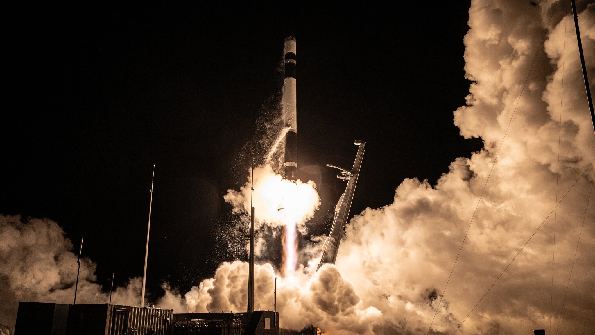 航天图片资料 · a black and white rocket launches into a dark night sky