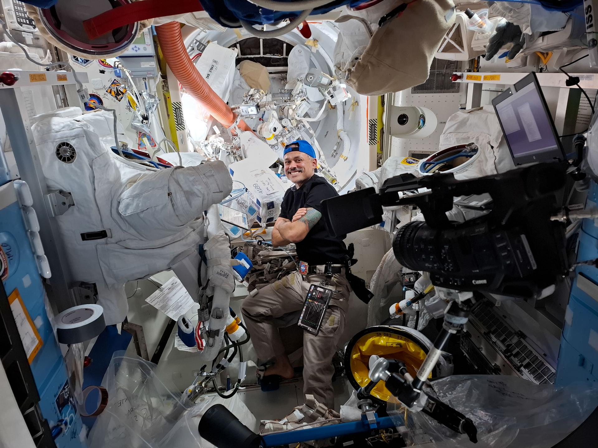 航天图片资料 · NASA astronaut and Expedition 75 flight engineer Anil Menon smiles for a portrait while conducting spacesuit maintenance inside the International Space Station's Quest airlock. Menon cleaned the spacesuit’s water-cooling loops that keep a spacewalker comfortable while working in the extreme environment of space.