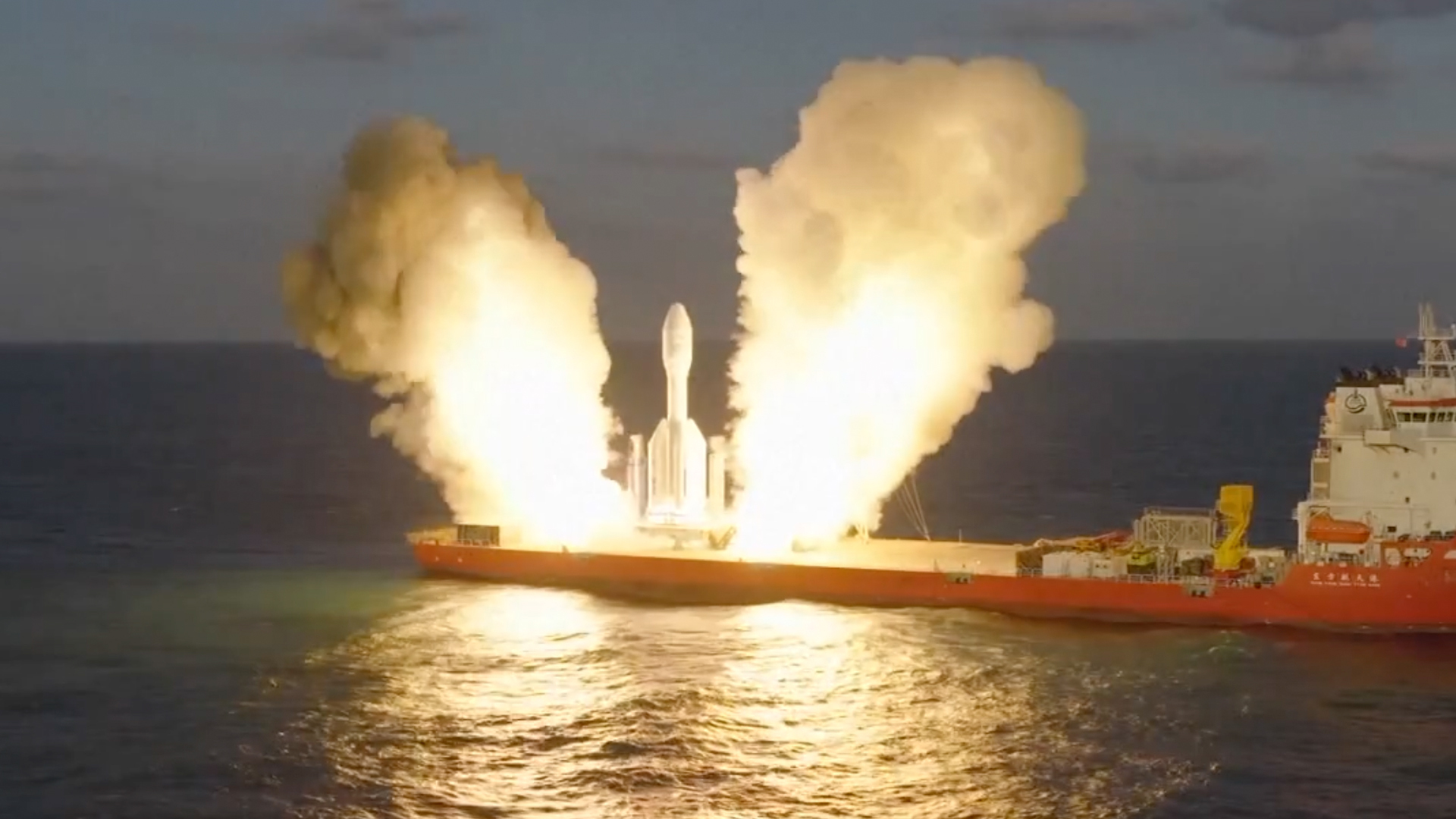 航天图片资料 · a short, stubby white rocket launches from a ship at sea