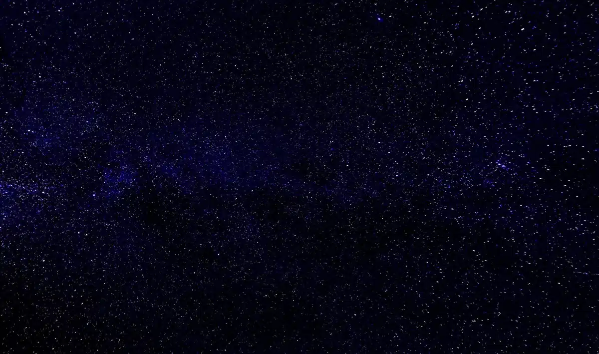 航天图片资料 · A wide-field view of distant galaxies and star clusters photographed through a telescope, showing the vast cosmic landscape that Roman will survey, with billions of stars and nebulae scattered across the frame.