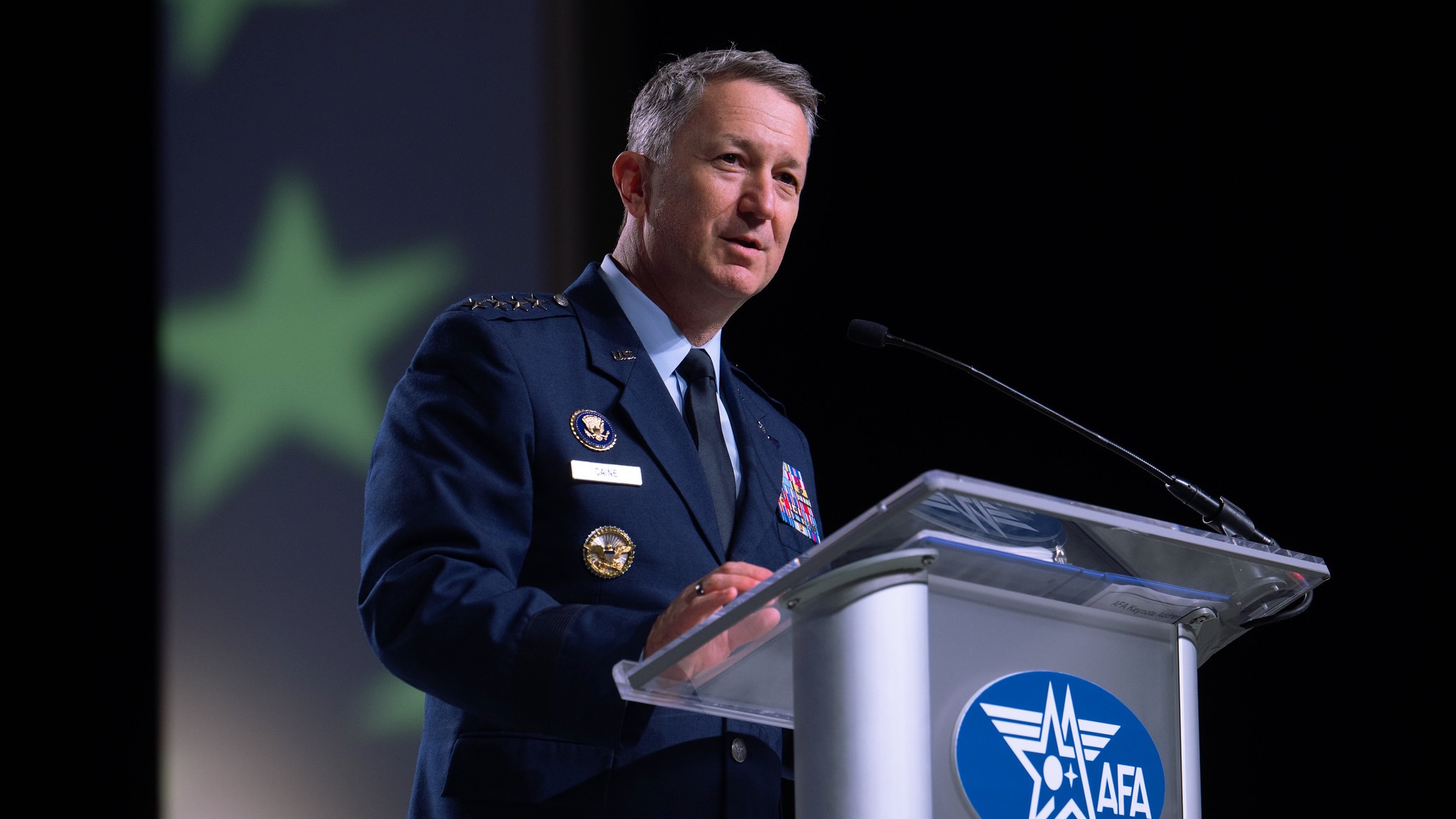 航天图片资料 · a military man in a blue uniform speaks at a silver lectern