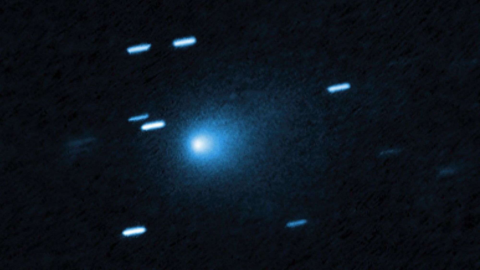 航天图片资料 · A bunch of blue streaks across a dark background. One blue dot in the middle is hazy.