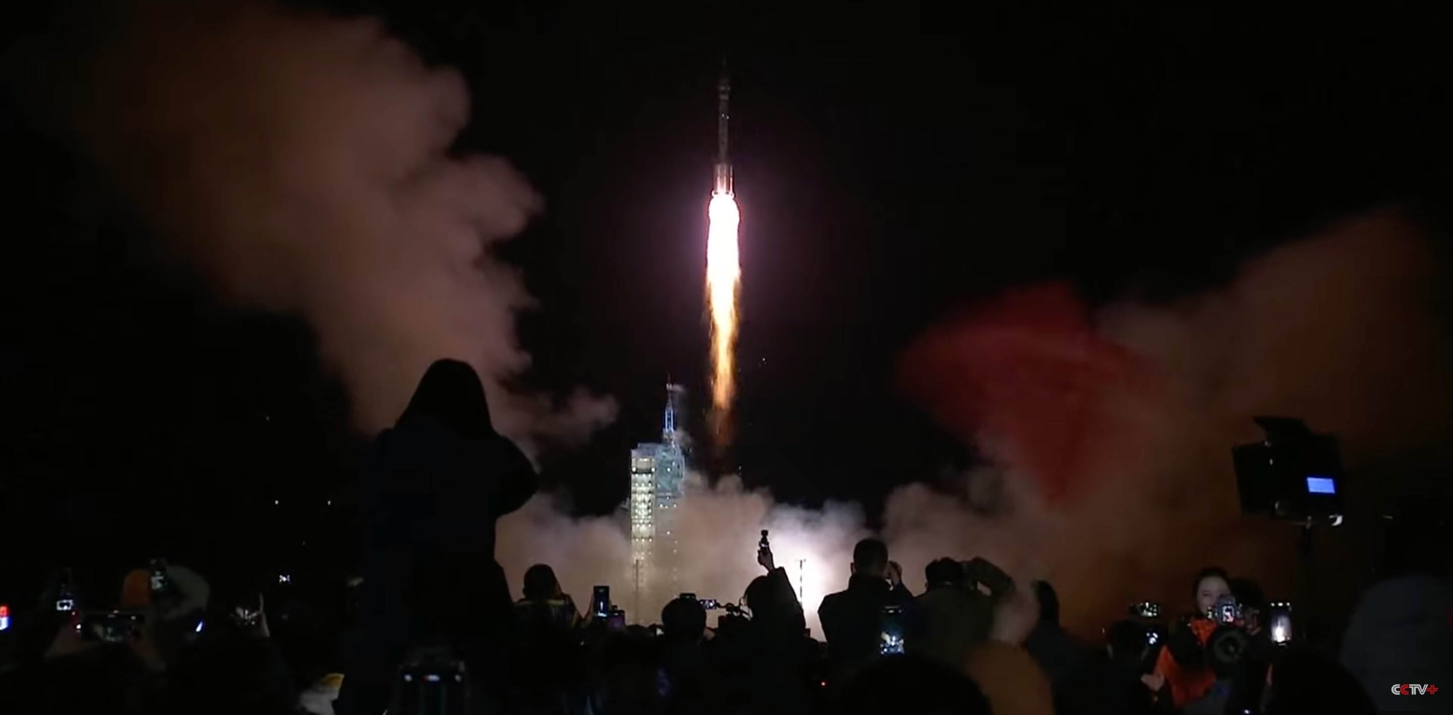 航天图片资料 · a white rocket launches into a dark night sky