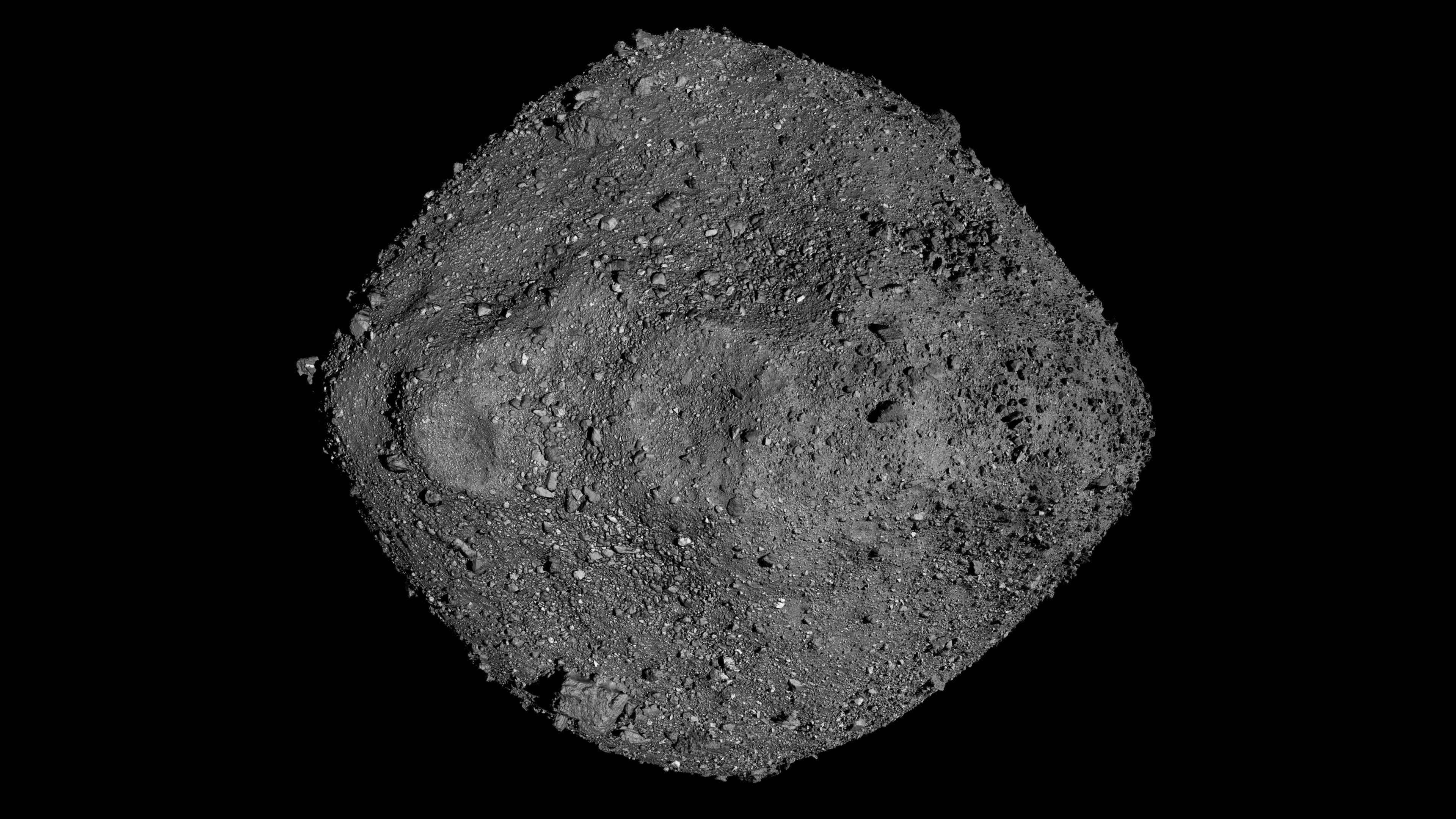 航天图片资料 · A gray rock with small pebbles on it against a dark background.