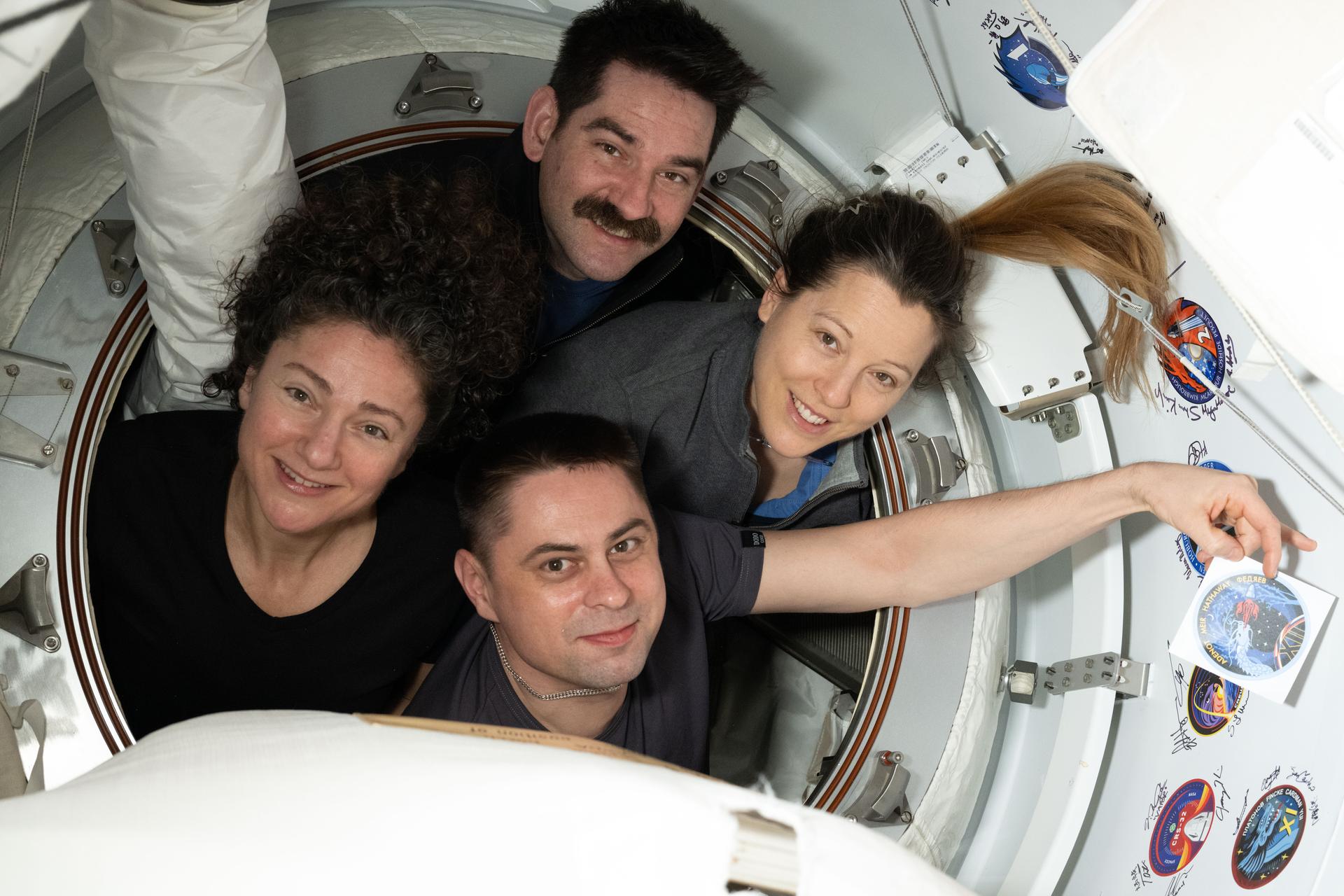 航天图片资料 · The four members of NASA's SpaceX Crew-12 mission pose for a portrait inside the vestibule between the SpaceX Dragon spacecraft and the International Space Station. Clockwise from left are, NASA astronauts Jessica Meir and Jack Hathaway, ESA (European Space Agency) astronaut Sophie Adenot, and Roscosmos cosmonaut Andrey Fedyaev who is displaying their mission's insignia sticker.