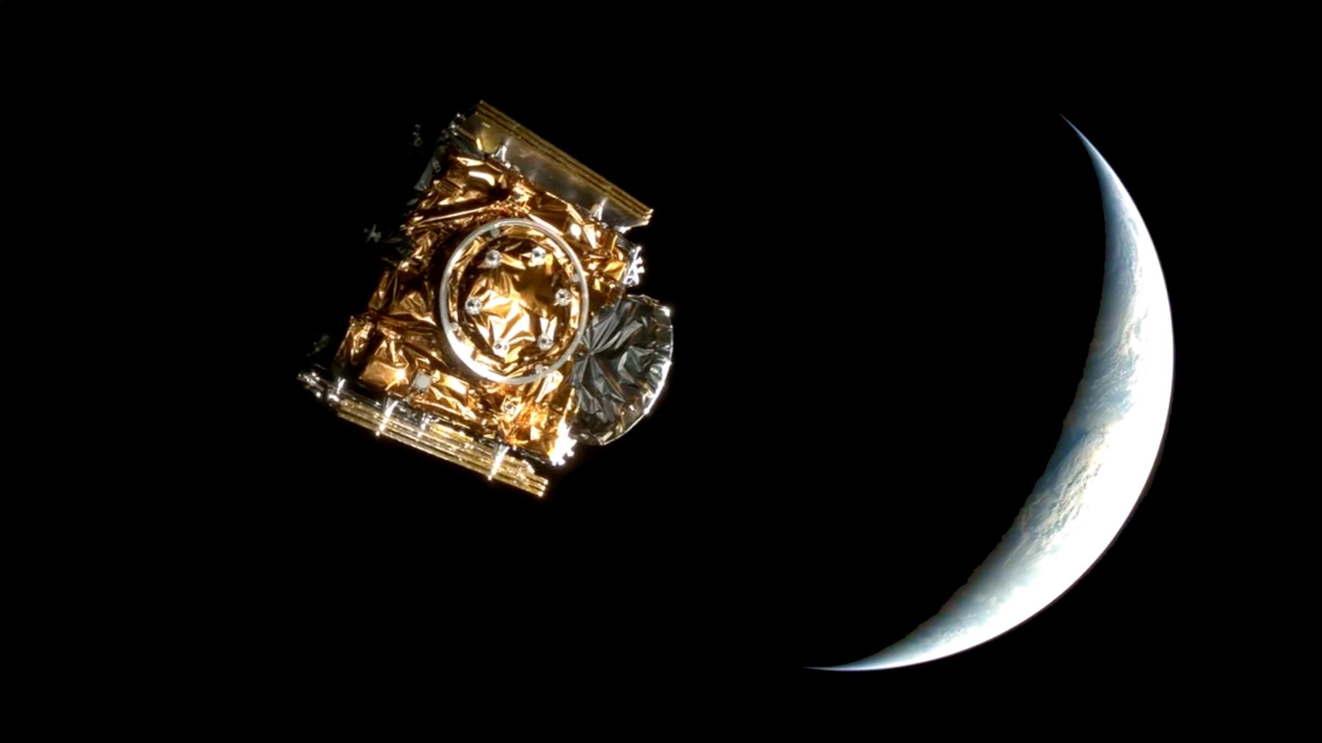 航天图片资料 · a cube-shaped spacecraft wrapped in foil floats on a black background