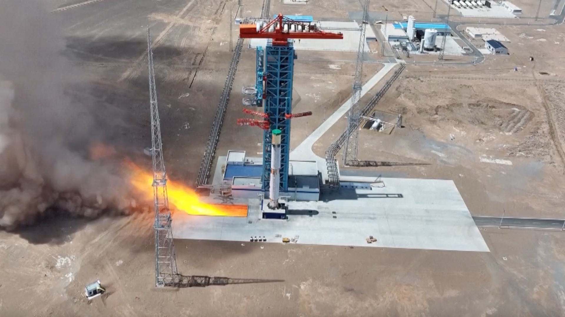 航天图片资料 · long-distance photo of a white rocket firing its engines on a launch pad