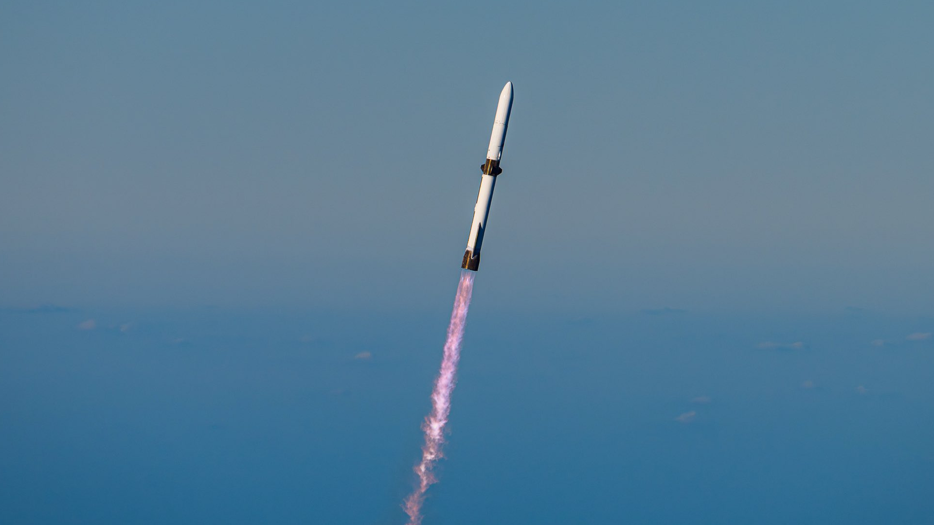 航天图片资料 · a white rocket climbs into a clear blue sky