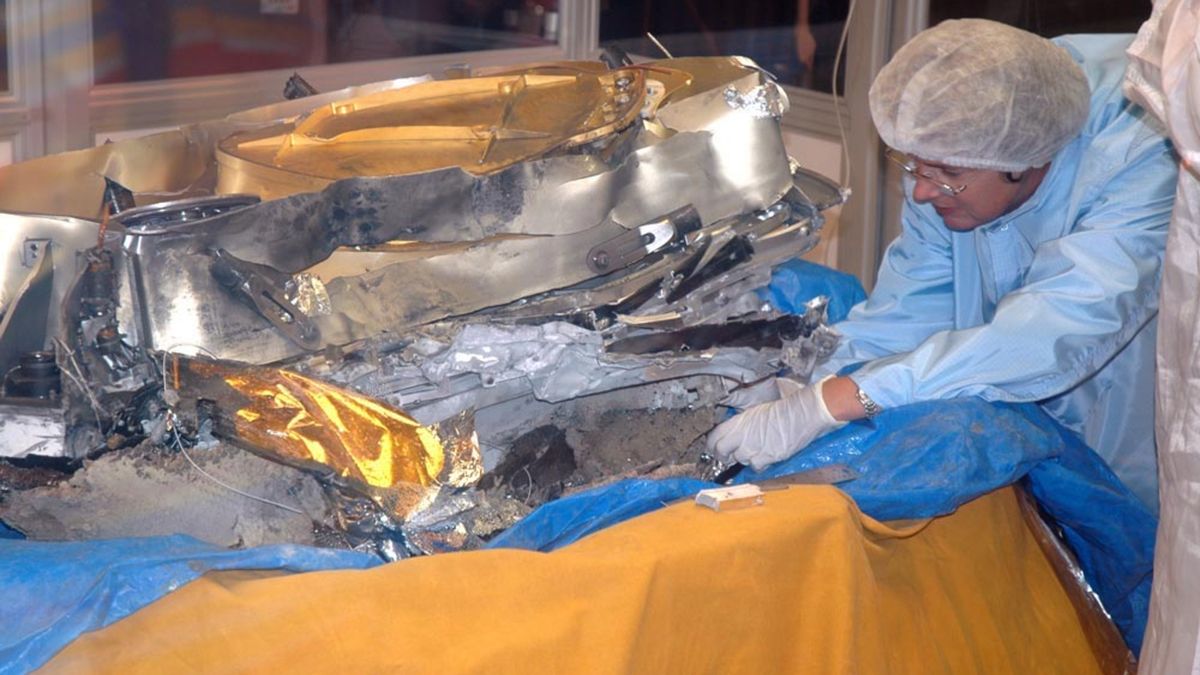 航天图片资料 · A scientist in protective gear trying to secure solar wind samples from crashed Genesis spacecraft