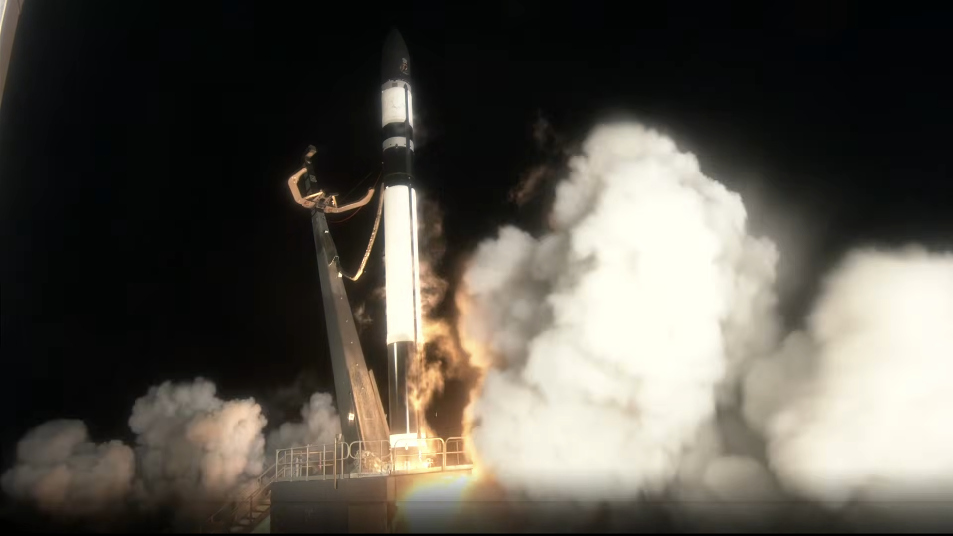 航天图片资料 · A dark rocket ignites its engines, lifting off a launch pad in a dark night setting.