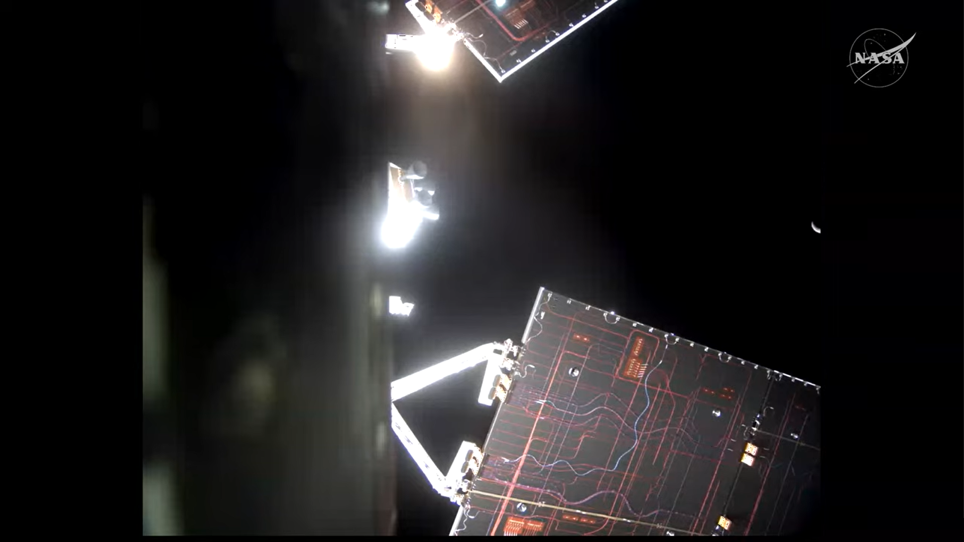 航天图片资料 · The Artemis II Orion spacecraft and its solar arrays appear in the foreground, with a sliver of Moon showing in the black background of space.