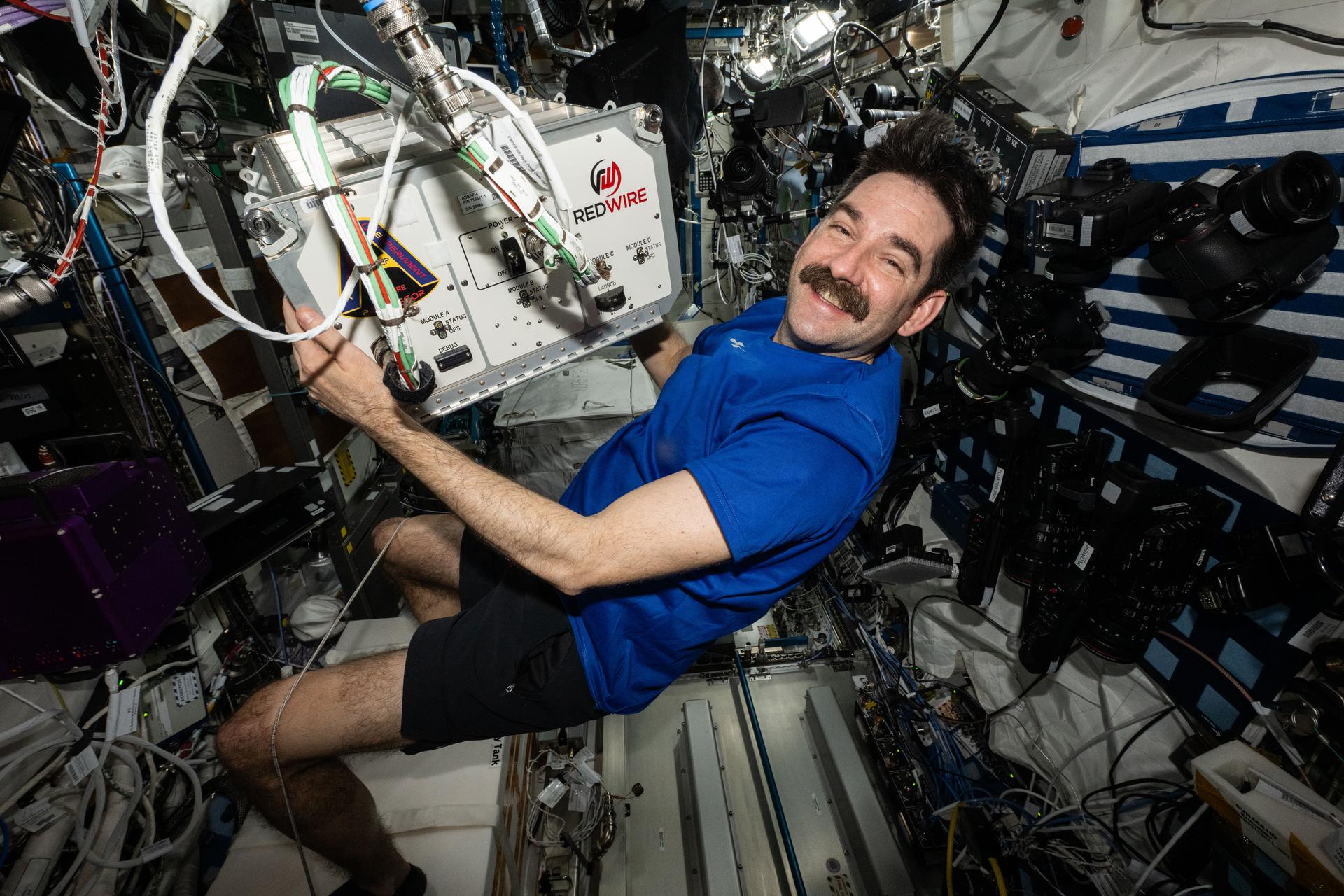 航天图片资料 · NASA astronaut and Expedition 75 flight engineer Jack Hathaway carries the Advanced Space Experiment Processer-4 (ADSEP-4) and relocates it for installation inside the International Space Station's Destiny laboratory module. ADSEP-4 houses research samples for processing in microgravity, can be launched aboard a SpaceX Dragon or Northrop Grumman's Cygnus XL spacecraft for powered science, and installed in EXPRESS racks aboard the orbital outpost for experimentation.