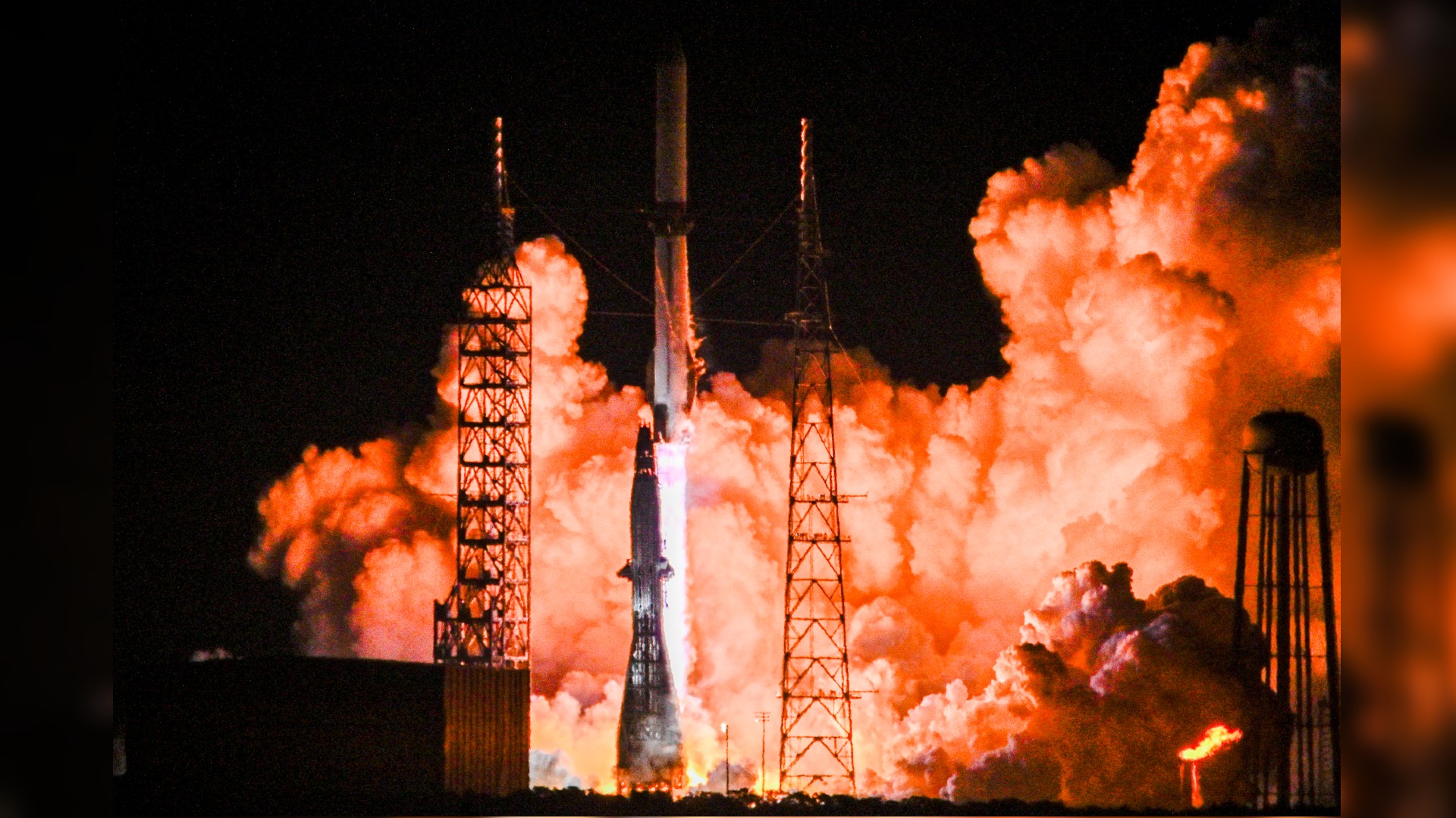 航天图片资料 · a white rocket launches into a dark night sky