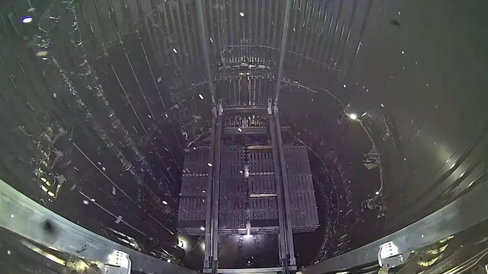 航天图片资料 · A dark payload bay with bits floating about.