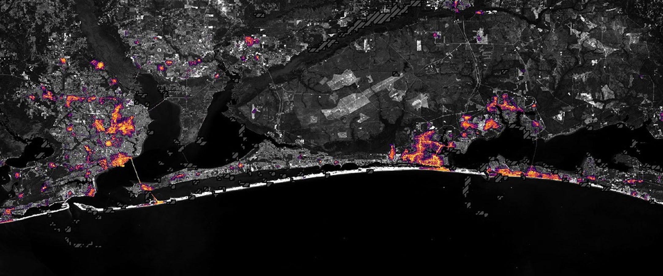 航天图片资料 · Nighttime lights along the Florida Panhandle coast on October 11, 2026, after Hurricane Isaias, with fewer and dimmer lights in Pensacola and Destin and gaps along the road between them.