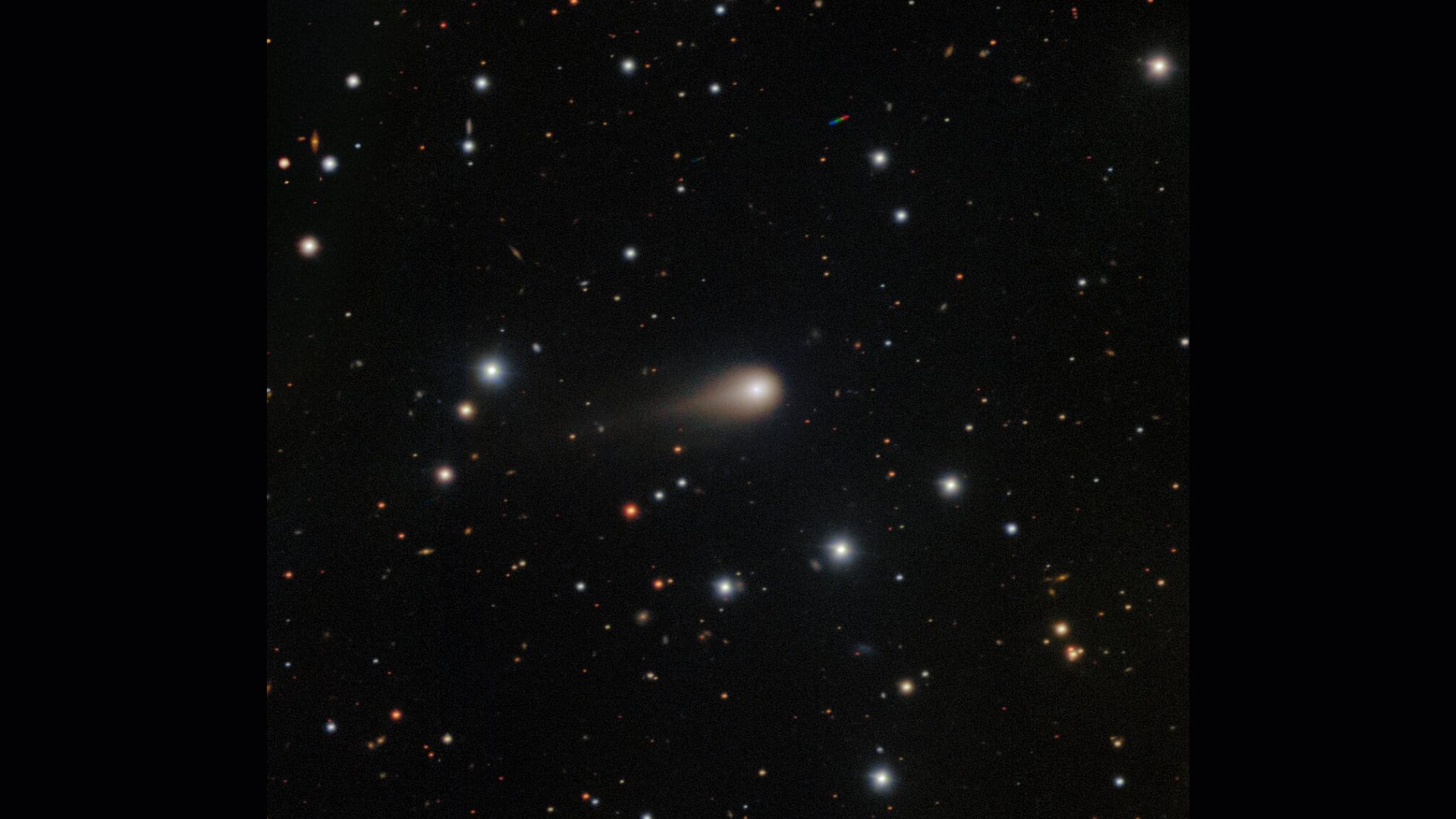 航天图片资料 · A streak of white shows interstellar comet 3I/ATLAS in the center of a starry night sky