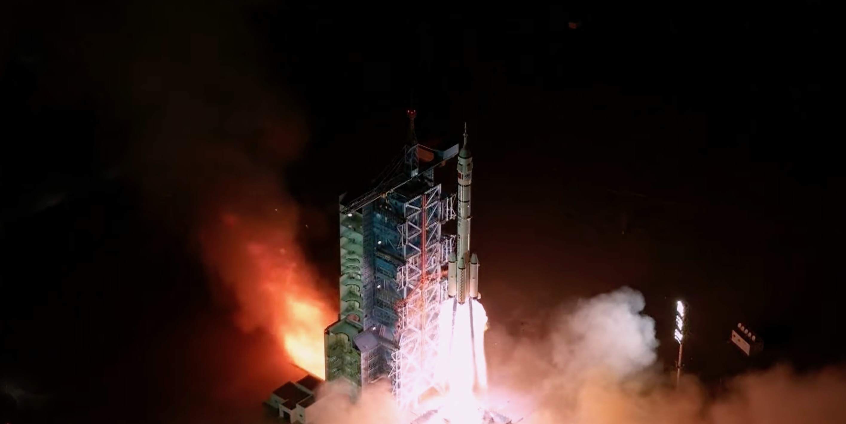 航天图片资料 · a white rocket launches into a dark night sky
