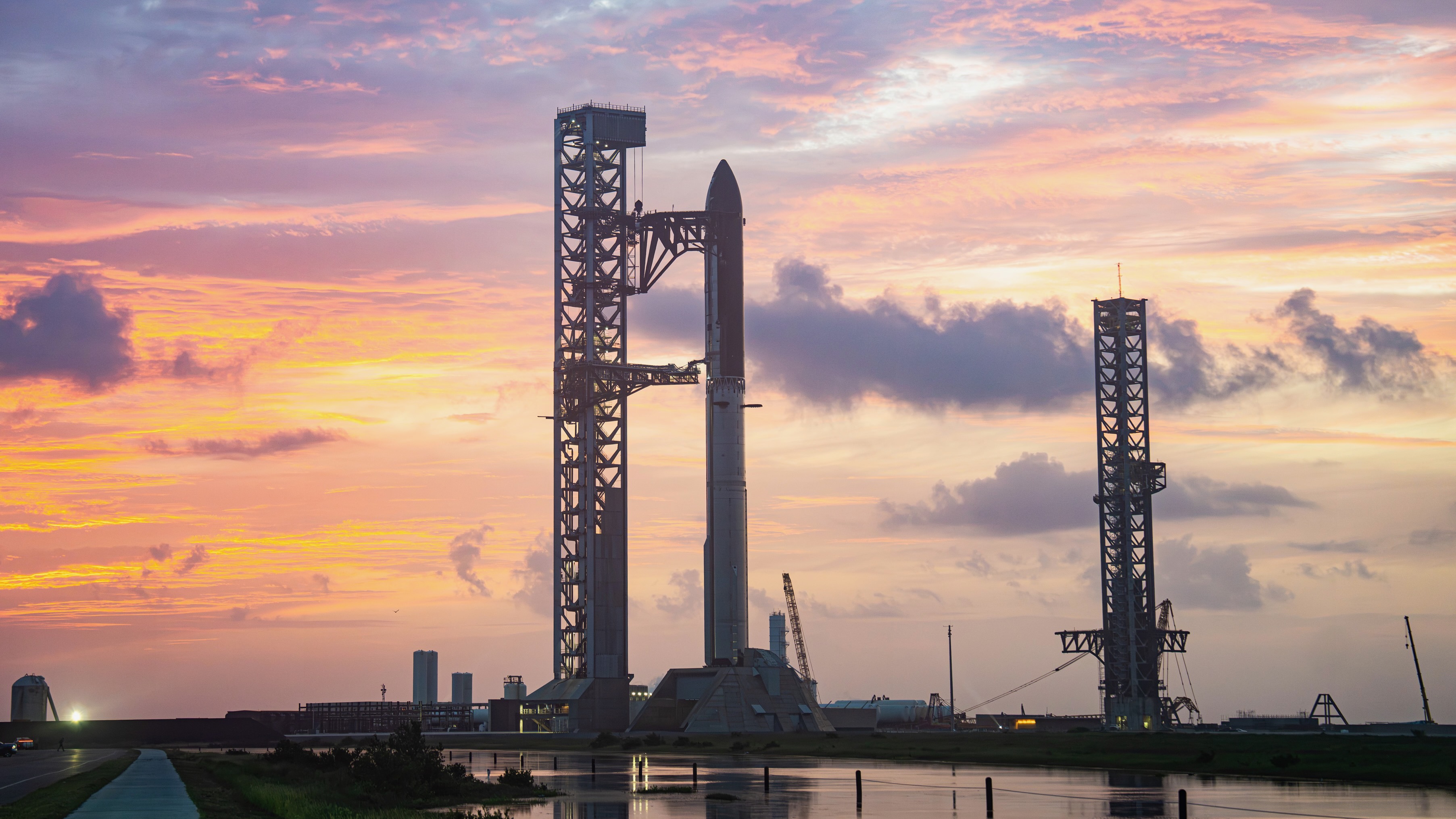航天图片资料 · a giant rocket stands on a launch pad against a sunset sky