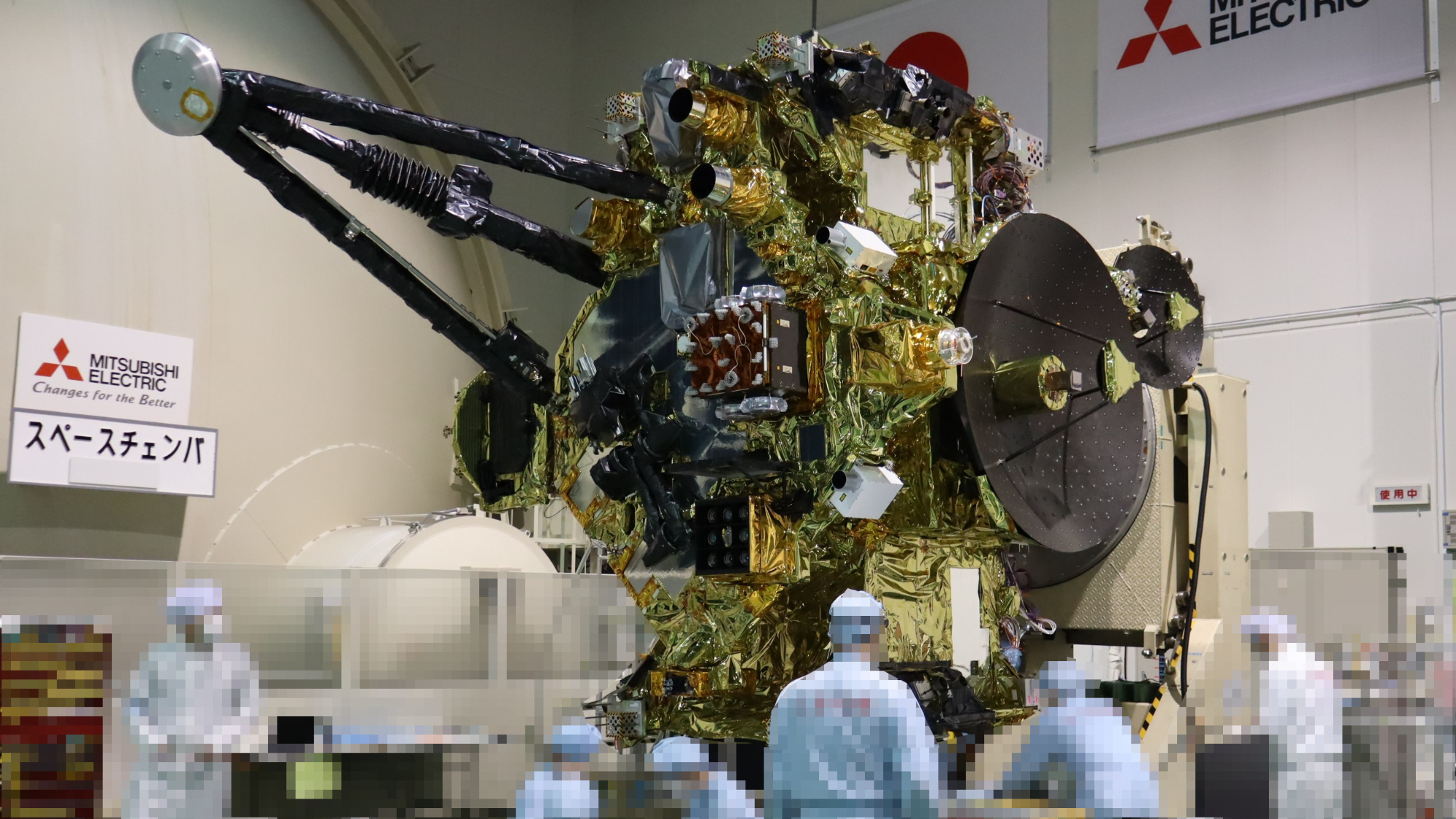 航天图片资料 · a handful of technicians work with a large spacecraft in a cleanroom