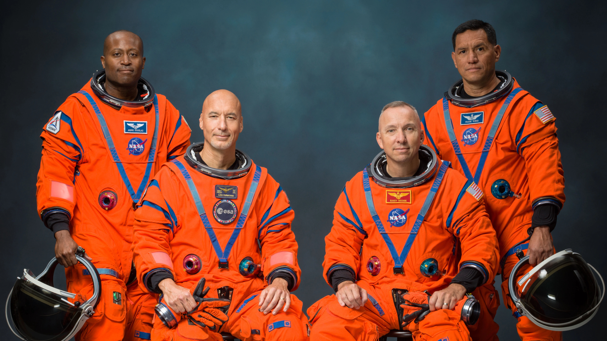 航天图片资料 · The four male astronauts of NASA's Artemis 3 mission in a portrait wearing their orange spacesuits. They are: Andre Douglas, Luca Parmitano, Randy Bresnick and Frank Rubio.
