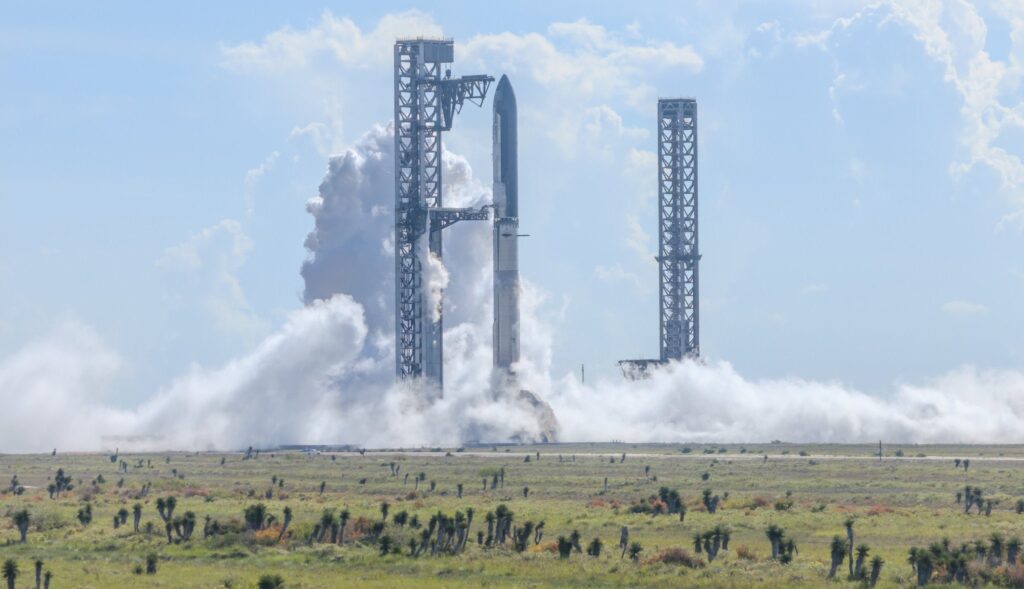 航天图片资料 · Fully stacked Flight 14 Starship mounted on OLP-2 and held by the launch tower Chopsticks and the redeveloped OLP-1 launch tower can is visible in the background (Starbase, Texas).