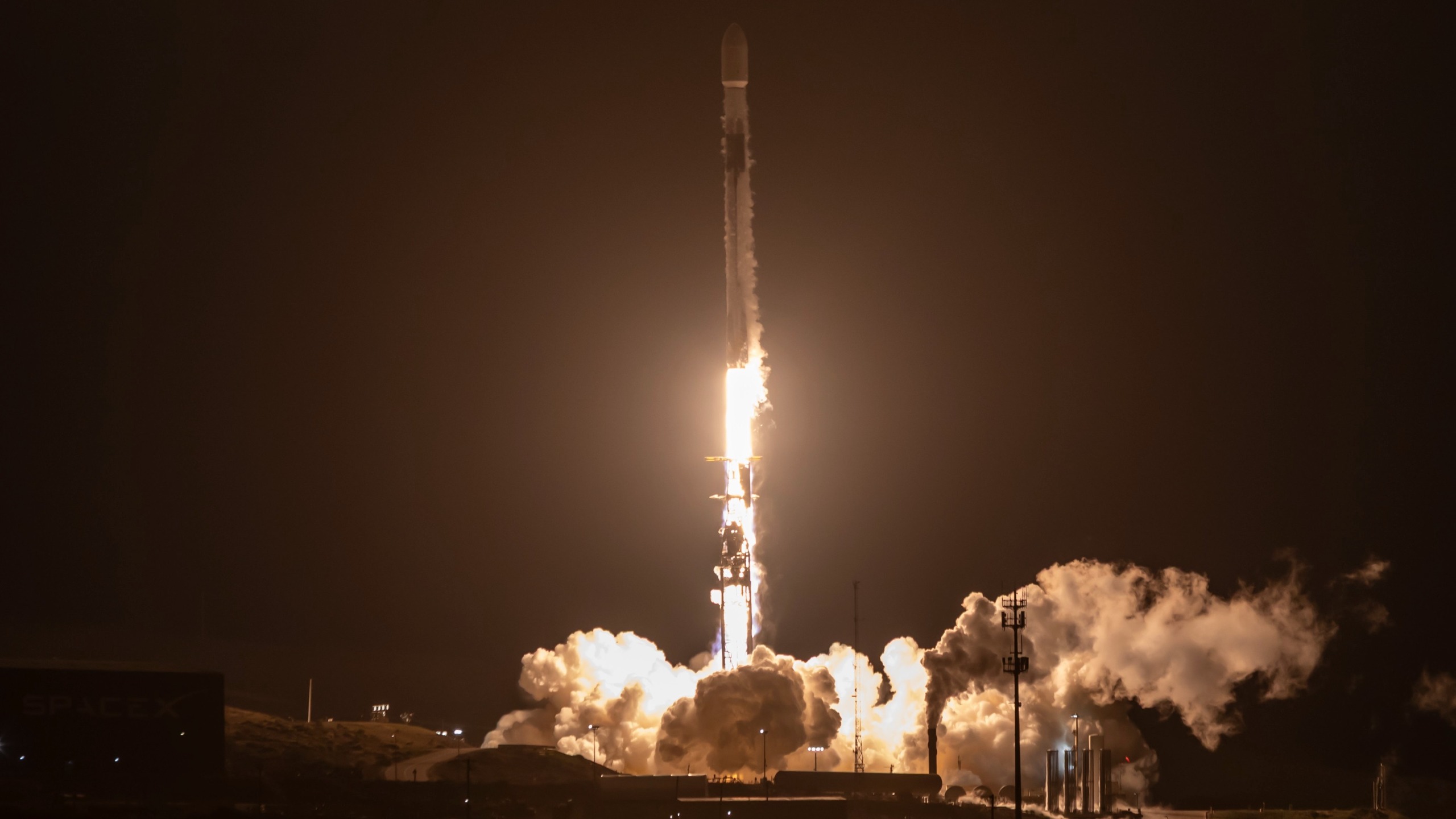 航天图片资料 · a black and white rocket launches into a dark night sky
