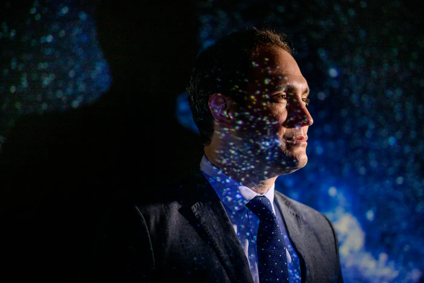 航天图片资料 · Jonathan Blazek, Northeastern astrophysicist, stands against a projection of stars.