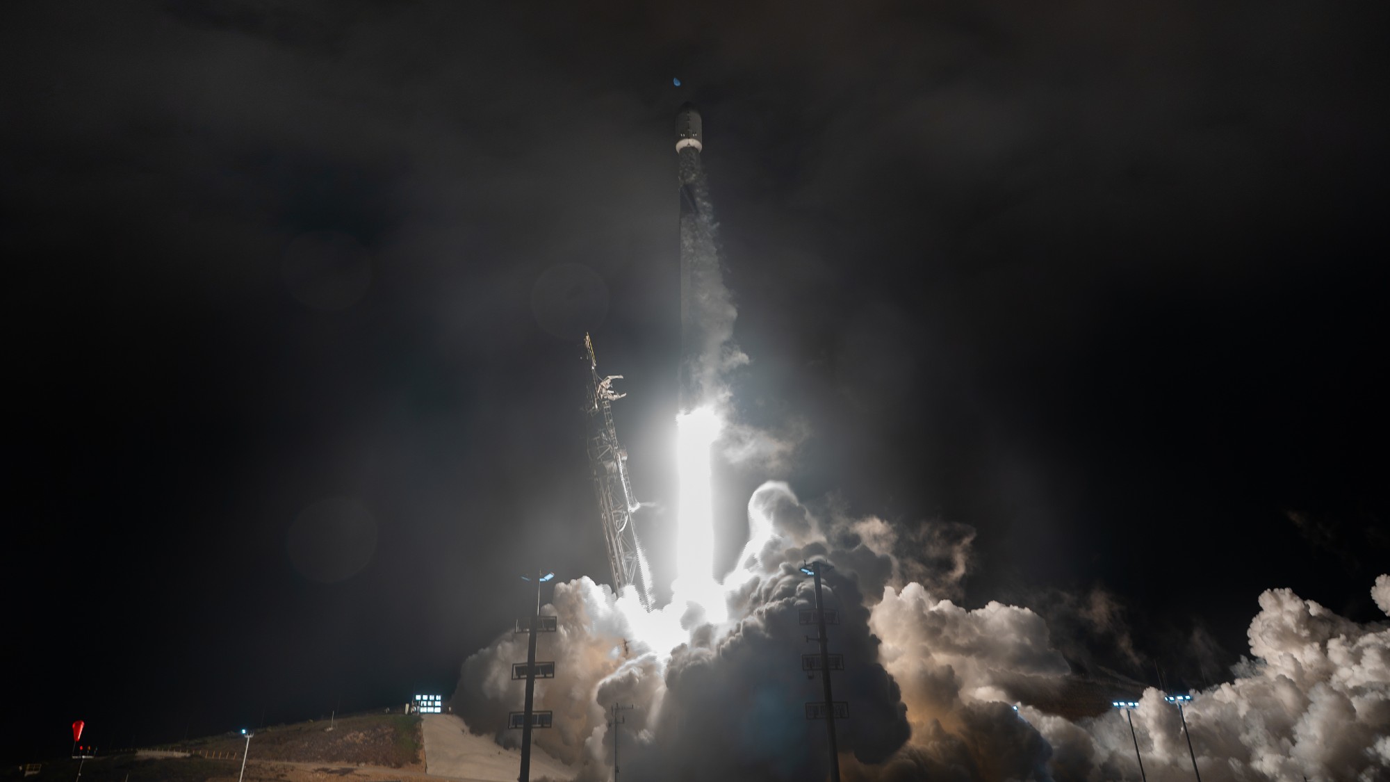 航天图片资料 · a white rocket lifts off above a plume of fire and smoke